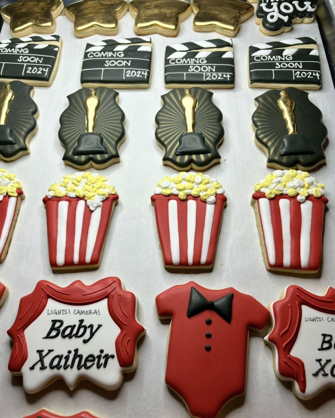 Hollywood themed baby shower cookies with popcorn and clapboards